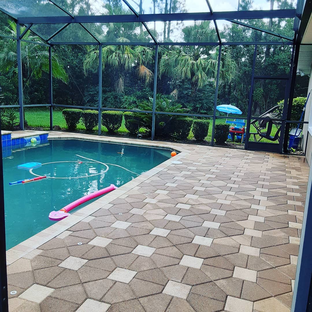 Clean pool deck pavers around a swimming pool